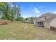 Spacious backyard featuring a lawn, wooden fence, mature trees, and a screened porch for outdoor enjoyment at 5004 Clowser Minnow Ct, Wake Forest, NC 27587