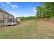 Expansive backyard with a well-maintained lawn, wooden fence, and a screened porch, perfect for outdoor gatherings at 5004 Clowser Minnow Ct, Wake Forest, NC 27587