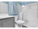 Bathroom features blue walls, gray vanity, modern sink, toilet, and glass shower at 5004 Clowser Minnow Ct, Wake Forest, NC 27587