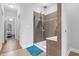 Ensuite bath with glass shower, vanity, tile floors, and open toilet area at 5004 Clowser Minnow Ct, Wake Forest, NC 27587