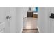 View down hall to a bathroom featuring dark cabinets, garden tub, separate shower, and tile floors at 5004 Clowser Minnow Ct, Wake Forest, NC 27587