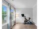Bedroom featuring home gym area, natural light, hardwood floors and blue curtains at 5004 Clowser Minnow Ct, Wake Forest, NC 27587