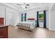 This bedroom has hardwood floors, tray ceilings and blue curtains at 5004 Clowser Minnow Ct, Wake Forest, NC 27587