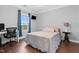Well-lit bedroom featuring hardwood floors, desk, and window with view to the outside at 5004 Clowser Minnow Ct, Wake Forest, NC 27587