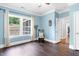 A spacious bedroom with beautiful blue walls, hardwood floors, and ample natural light at 5004 Clowser Minnow Ct, Wake Forest, NC 27587