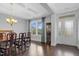 Elegant dining room featuring coffered ceiling, large windows, and chandelier lighting at 5004 Clowser Minnow Ct, Wake Forest, NC 27587