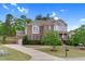 Charming two-story brick home with blue accents, lush landscaping, and a welcoming front yard at 5004 Clowser Minnow Ct, Wake Forest, NC 27587