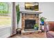 Close-up of a stone fireplace with mounted television and decorative accents in the living room at 5004 Clowser Minnow Ct, Wake Forest, NC 27587