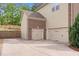 Spacious three car garage with brick and beige siding, providing ample parking and storage at 5004 Clowser Minnow Ct, Wake Forest, NC 27587