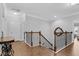 Upstairs hallway featuring hardwood floors, access to multiple rooms and ornamental wood and iron banisters at 5004 Clowser Minnow Ct, Wake Forest, NC 27587