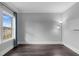 Home office featuring dark wood floors, large window with curtains, and neutral walls and trim at 5004 Clowser Minnow Ct, Wake Forest, NC 27587