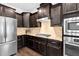 A modern kitchen features stainless steel appliances, granite countertops, and dark cabinetry at 5004 Clowser Minnow Ct, Wake Forest, NC 27587