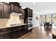 Gourmet kitchen with stainless steel appliances, granite counters, and dark wood cabinets at 5004 Clowser Minnow Ct, Wake Forest, NC 27587