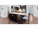 Kitchen island with barstool seating, granite countertop and stainless steel appliances at 5004 Clowser Minnow Ct, Wake Forest, NC 27587