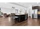 A kitchen island overlooks an open floor plan with modern chairs and stainless appliances at 5004 Clowser Minnow Ct, Wake Forest, NC 27587
