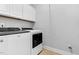 Functional laundry room with modern appliances and white cabinets for storage at 5004 Clowser Minnow Ct, Wake Forest, NC 27587