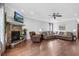 Open living room features a stone fireplace with mounted television, nice floors and neutral walls at 5004 Clowser Minnow Ct, Wake Forest, NC 27587