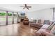 Open living room features a stone fireplace, ceiling fan and large windows for plenty of light at 5004 Clowser Minnow Ct, Wake Forest, NC 27587