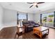 This expansive living room has hardwood floors, a leather sofa and lots of light at 5004 Clowser Minnow Ct, Wake Forest, NC 27587