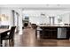 Open floor plan displaying kitchen with island and a living room with a stone fireplace at 5004 Clowser Minnow Ct, Wake Forest, NC 27587