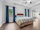 This bedroom has dark hardwood floors, tray ceilings and light-filled windows at 5004 Clowser Minnow Ct, Wake Forest, NC 27587