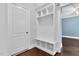 Mudroom with white built-in shelving unit and entry to another room at 5004 Clowser Minnow Ct, Wake Forest, NC 27587