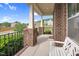 Inviting front porch with brick columns, a cozy bench, and neighborhood views at 5004 Clowser Minnow Ct, Wake Forest, NC 27587