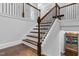 Elegant staircase with wood and iron railing leading to the second floor at 5004 Clowser Minnow Ct, Wake Forest, NC 27587