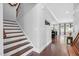 Inviting foyer featuring a staircase with wood treads and hardwood flooring, leading to the living spaces at 5004 Clowser Minnow Ct, Wake Forest, NC 27587