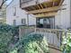 Back patio featuring mature landscaping and sliding glass doors leading to the interior of the home at 5078 Flint Ridge Pl, Raleigh, NC 27609