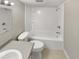 Bathroom featuring a tub and shower combo, white toilet and gray vanity with sink and chrome fixtures at 5078 Flint Ridge Pl, Raleigh, NC 27609