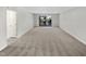 Spacious empty room with carpet and sliding glass doors leading to a balcony at 5078 Flint Ridge Pl, Raleigh, NC 27609