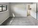 Empty bedroom with plush gray carpet and a large window providing natural light at 5078 Flint Ridge Pl, Raleigh, NC 27609