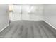 Empty bedroom area with carpet, multiple doors, and washer dryer connections for a functional space at 5078 Flint Ridge Pl, Raleigh, NC 27609