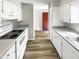 Bright kitchen featuring white cabinetry, modern countertops, and sleek appliances at 5078 Flint Ridge Pl, Raleigh, NC 27609