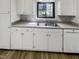 Close-up of kitchen sink area, showcasing modern cabinets and countertop space at 5078 Flint Ridge Pl, Raleigh, NC 27609