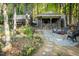 Inviting backyard with stone patio, fire pit, outdoor kitchen, and lush landscaping at 5129 Bartons Enclave Ln, Raleigh, NC 27613