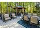 Outdoor deck with multiple seating areas, including a gazebo with a dining set, surrounded by lush greenery at 5129 Bartons Enclave Ln, Raleigh, NC 27613