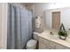 Bathroom showcasing a shower with patterned curtains, neutral tiles, and modern sink at 5129 Bartons Enclave Ln, Raleigh, NC 27613