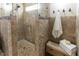Walk-in shower featuring exquisite natural stone tile work with a built-in bench for a spa-like feel at 5129 Bartons Enclave Ln, Raleigh, NC 27613