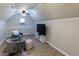 Finished bonus room with wood-look floors, seating, a TV, and a vaulted ceiling with recessed lighting at 5129 Bartons Enclave Ln, Raleigh, NC 27613