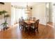 Elegant dining room with hardwood floors, an ornate chandelier, and natural lighting from the many windows at 5129 Bartons Enclave Ln, Raleigh, NC 27613
