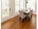 Hardwood floors in the bright dining room with door to patio and seating for six at 5129 Bartons Enclave Ln, Raleigh, NC 27613