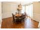 Traditional dining room with hardwood floors, ornate chandelier, and natural light from large windows at 5129 Bartons Enclave Ln, Raleigh, NC 27613