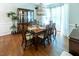 Bright dining room with hardwood floors, decorative china cabinet and traditional furniture at 5129 Bartons Enclave Ln, Raleigh, NC 27613