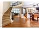 Elegant foyer with a curved staircase, hardwood floors, and a built-in bar at 5129 Bartons Enclave Ln, Raleigh, NC 27613
