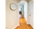 Hallway featuring hardwood floors, an arched doorway, neutral colored walls and white trim at 5129 Bartons Enclave Ln, Raleigh, NC 27613