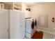 Functional laundry room with white cabinets, modern washer and dryer, and ample storage space at 5129 Bartons Enclave Ln, Raleigh, NC 27613