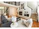 Open living room featuring a fireplace with built-ins, hardwood floors, and staircase at 5129 Bartons Enclave Ln, Raleigh, NC 27613