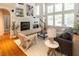 Bright living room features a fireplace, hardwood floors, and large windows for plenty of natural light at 5129 Bartons Enclave Ln, Raleigh, NC 27613